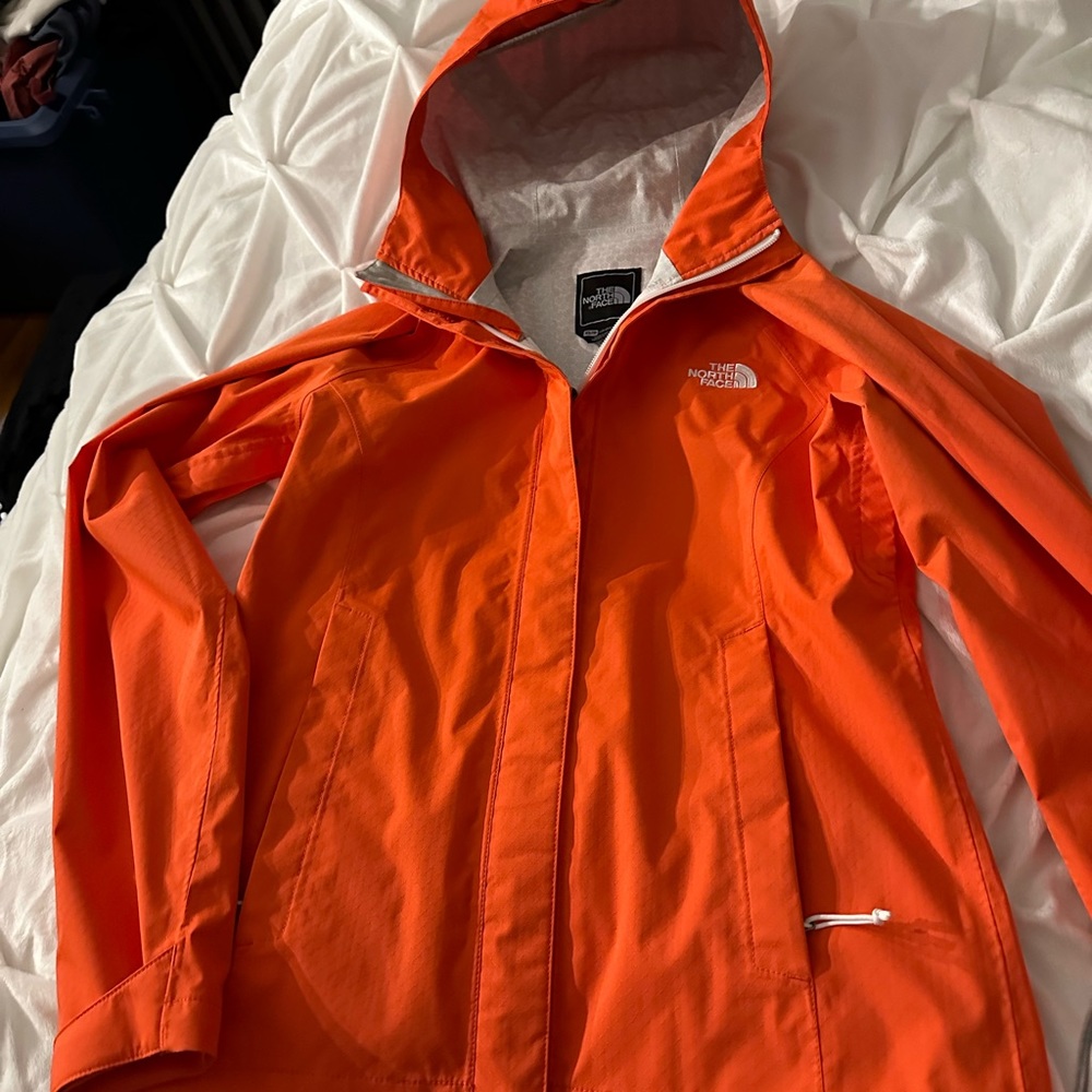 Ladies Xsm Northface raincoat in a rare orange color . Only worn a few times